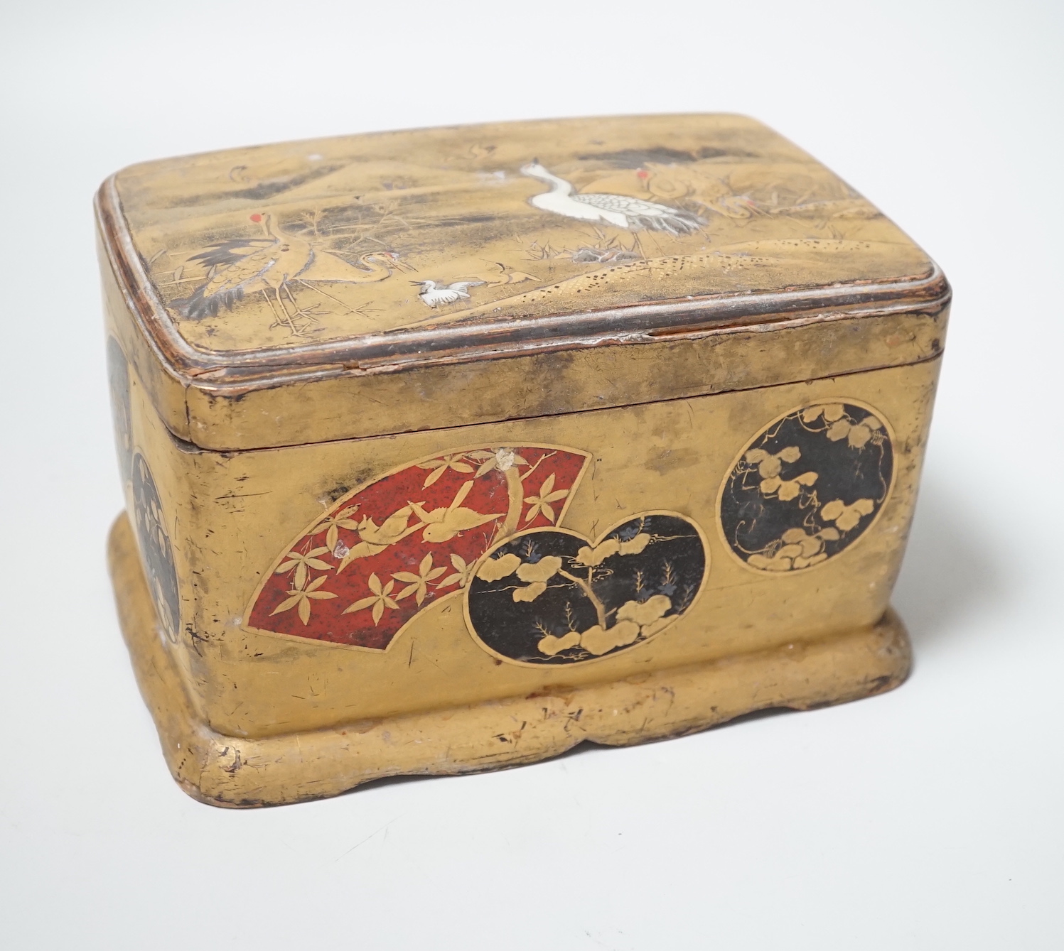 A Japanese lacquered box and cover accommodating a small collection of seashells